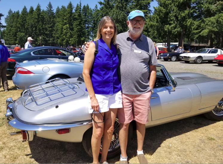 Mike Boyd & Lynn Szalay in front of their 1970 E Type convertible.