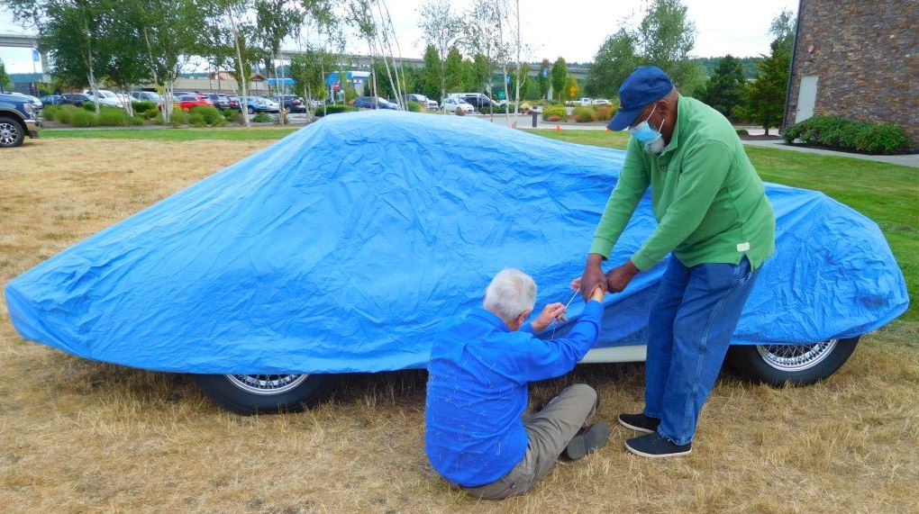 Kurt Jacobson and Curt Kyle working on covering his XK120.   Trying to protect it from the rain!