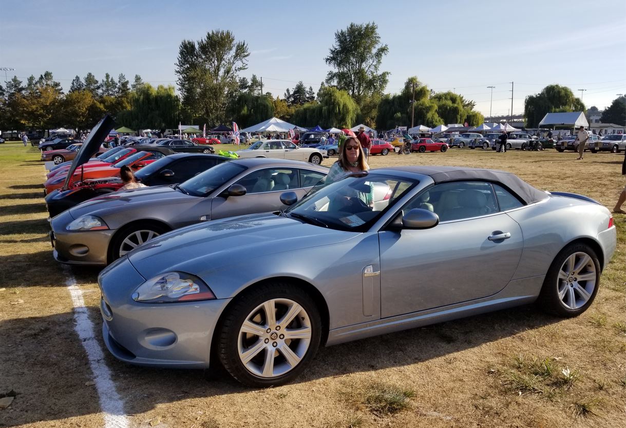 Cheryl Jacobson standing behind their 2007 XK which won First Place in Driven class in the Concours.