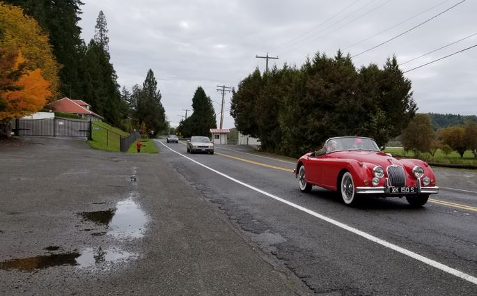 Coming down the road by Carnation Farms was Glen & Debbie Read in their red XK150S.