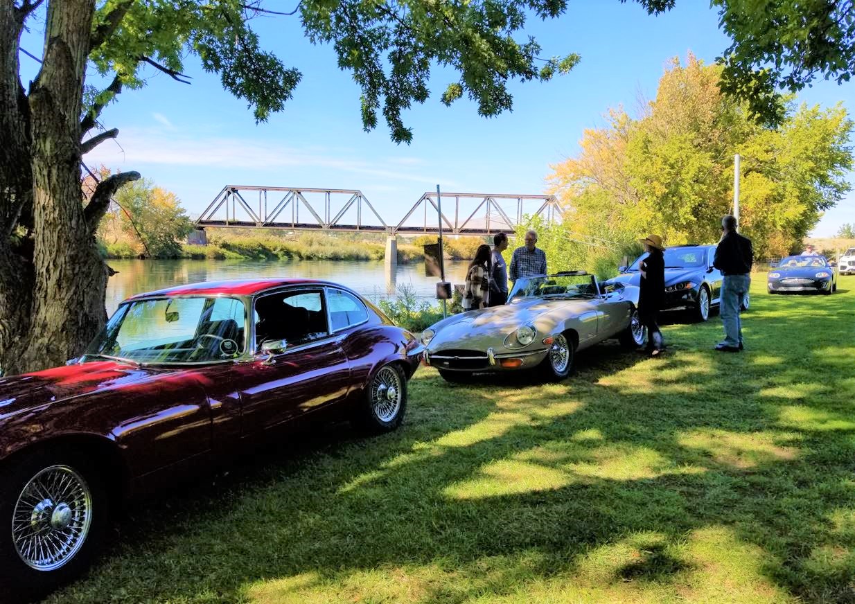 "After lunch we all drove to Brad Vancour's vineyard. Jaguars were lined up along the Yakima river.  Really nice location.  Old railroad bridge in backround."