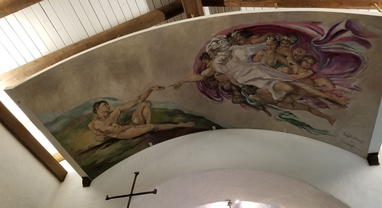 The ceiling had a mural painting that depicted a famous Michelangelo's painting from the Sistine Chapel, The Creation of Adam.